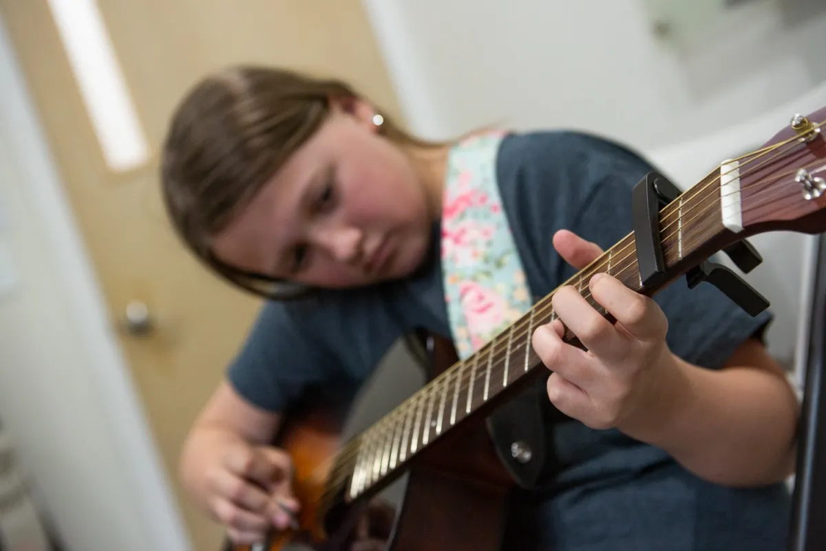 Student playing guitar